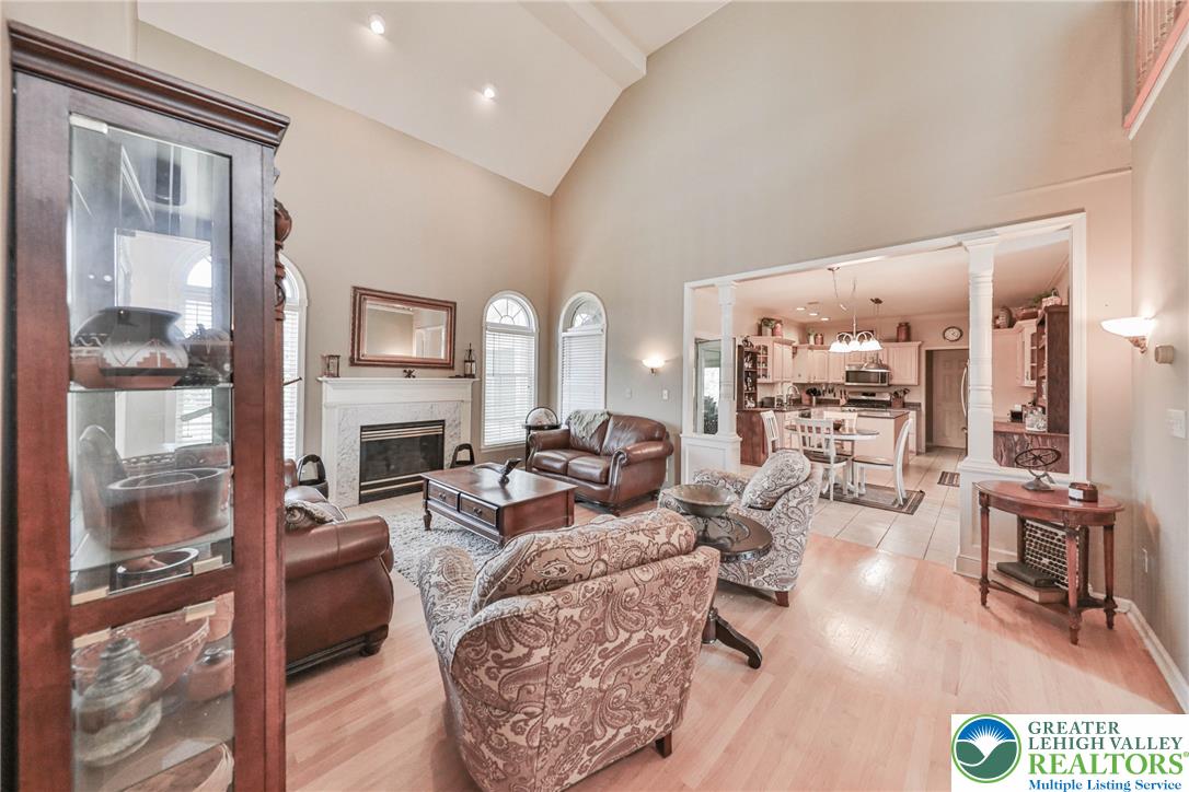 63 Long Road Lenhartsville, PA 19534 - Photo 39 of 100 Vaulted ceilings and hardwood floors define this open living space anchored by a classic fireplace.