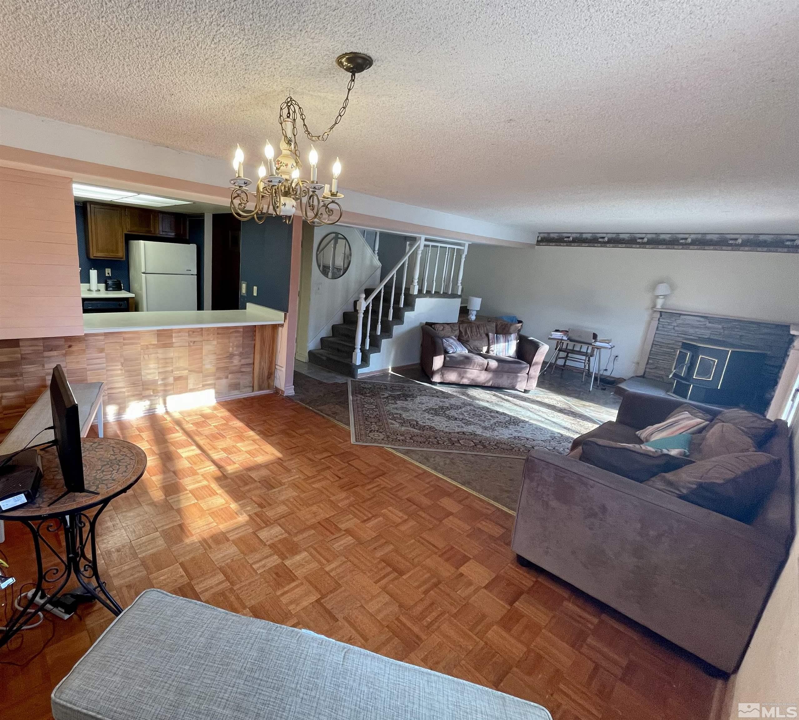 2606 Rayma Court Reno, NV 89503 - Photo 2 of 12 a living room with furniture a chandelier and a dining table