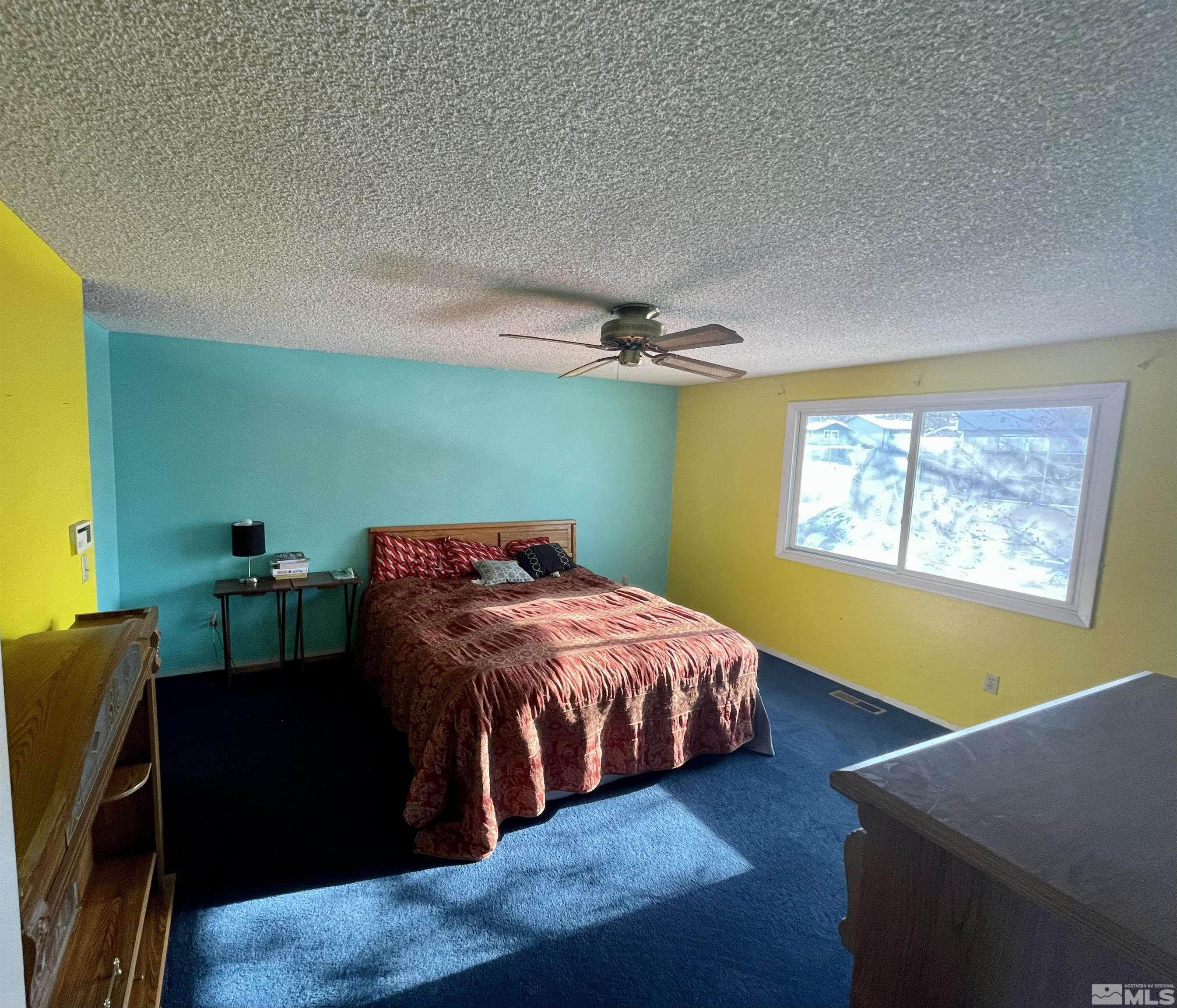 2606 Rayma Court Reno, NV 89503 - Photo 9 of 12 a bedroom with a bed and a flat screen tv