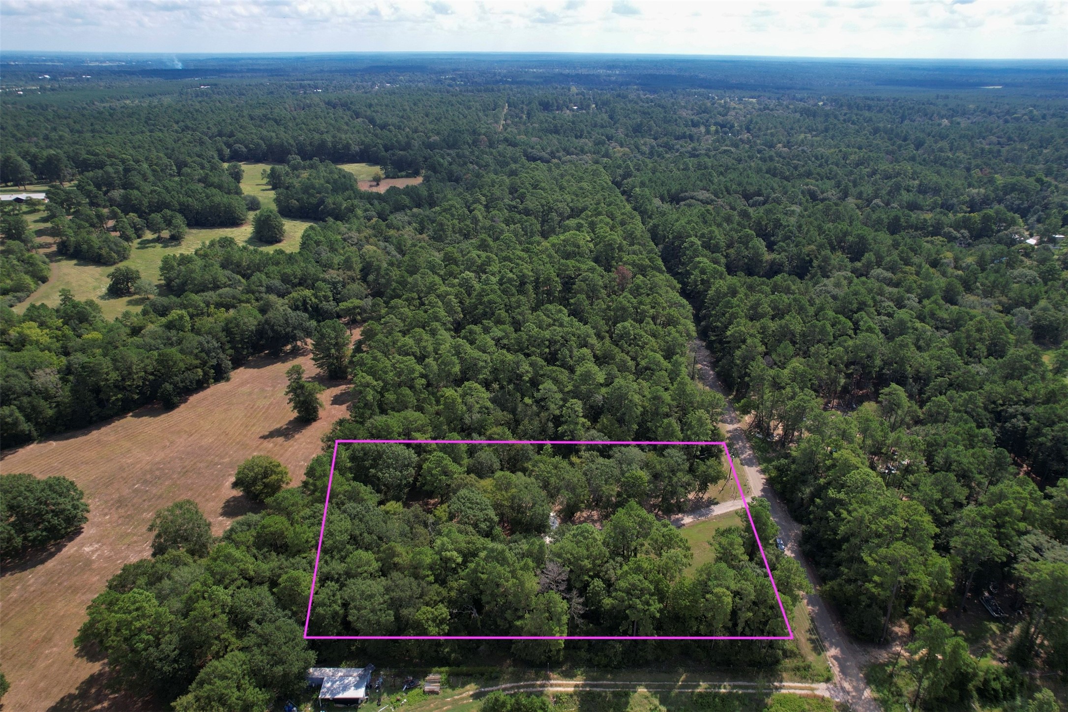 an aerial view of a house with a yard and lake view