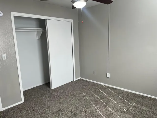 a view of an empty room with a fan