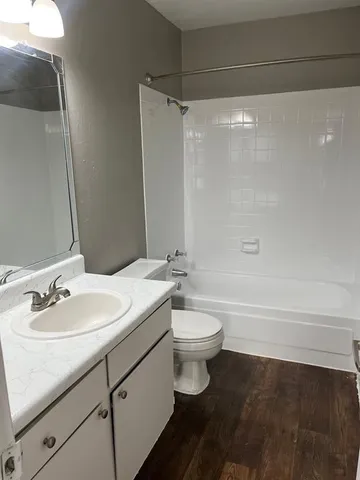 a bathroom with a sink a toilet and a bathtub