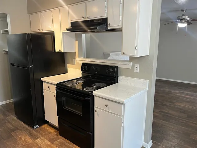 a kitchen with a stove and a refrigerator