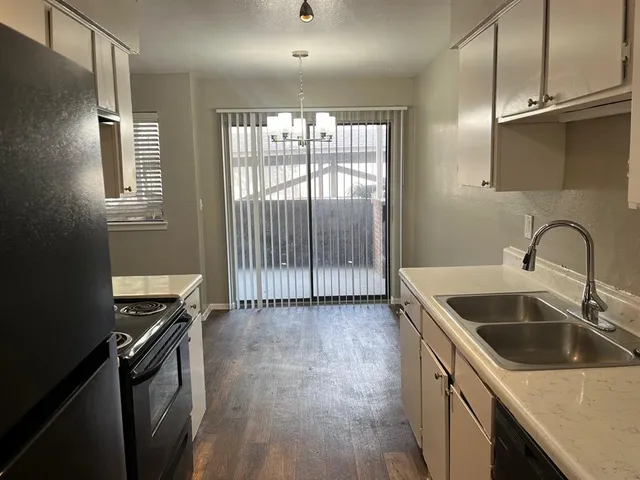 a kitchen that has a sink and a stove in it