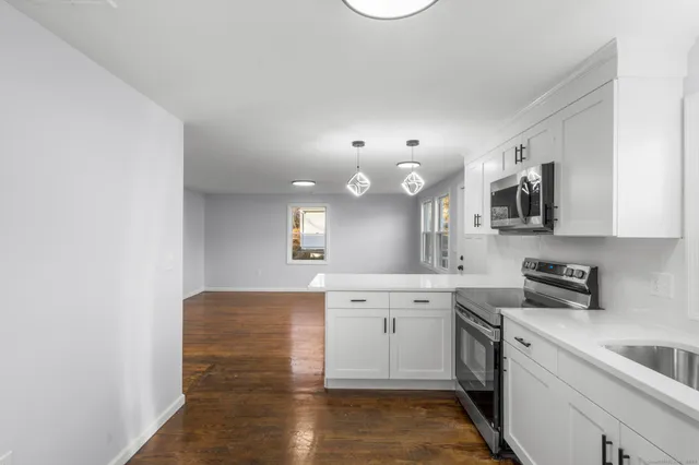 a kitchen with a sink cabinets and stainless steel appliances