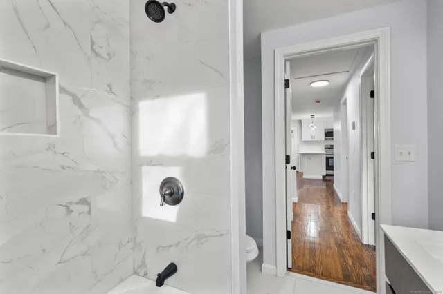 a view of a hallway with wooden floor