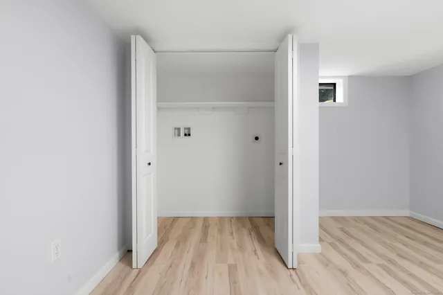 a view of a room with wooden floor