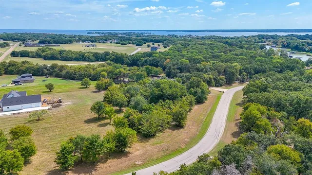 an aerial view of a house with a garden and lake view