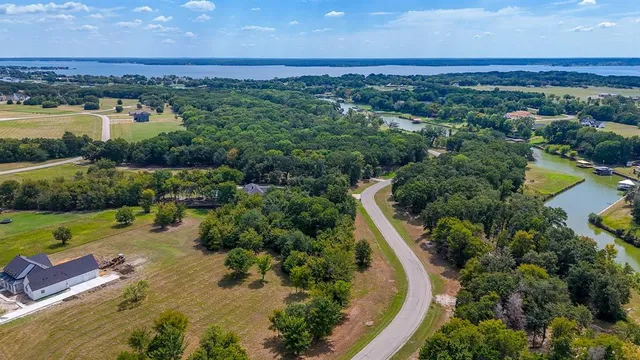an aerial view of a houses with outdoor space and lake view