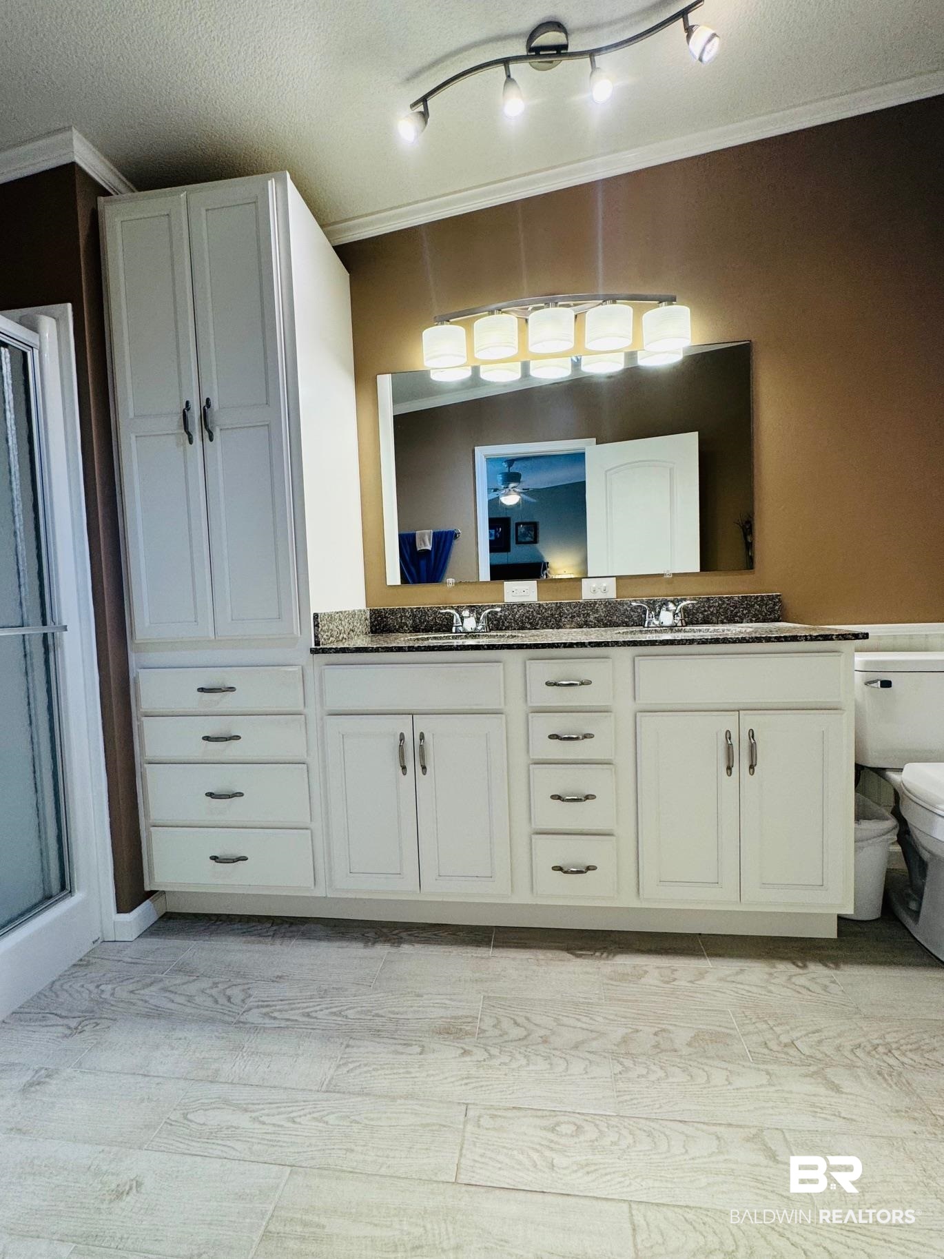 1165 Santa Anna Lane Lillian, AL 36549 - Photo 13 of 43 Bathroom with double vanity, a sink, toilet, and a shower stall