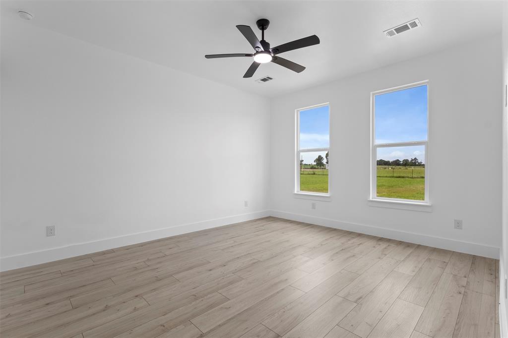 180 County Road 2245 Emory, TX 75440 - Photo 14 of 34 an empty room with wooden floor and windows