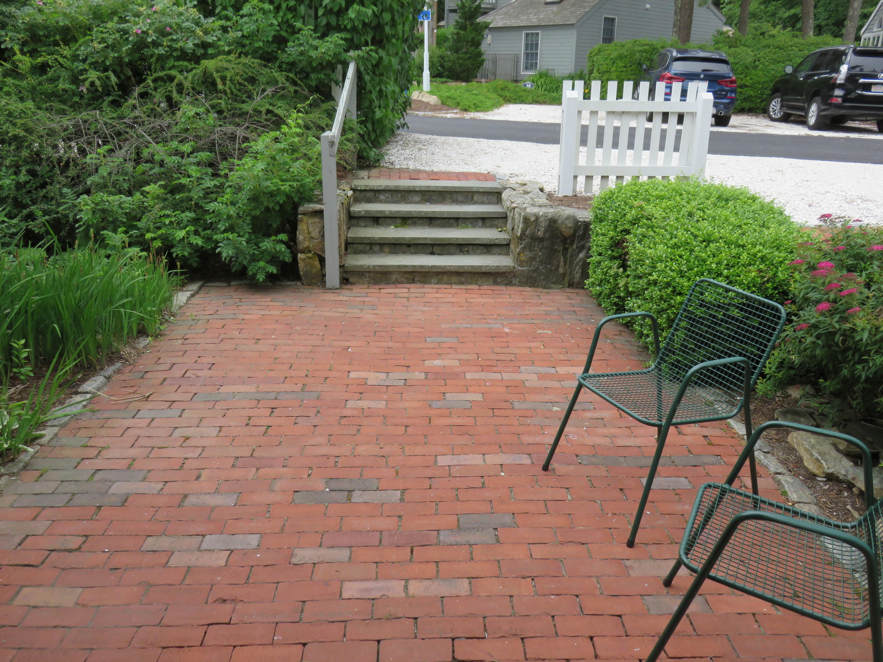 23 Brant Rock Road Mashpee, MA 02649 - Photo 27 of 34 a view of a chairs and table in the patio with a garden