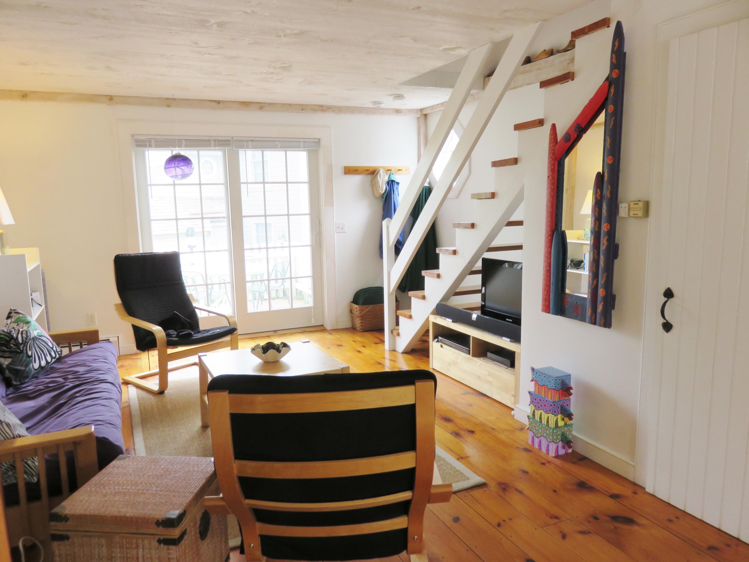 23 Brant Rock Road Mashpee, MA 02649 - Photo 7 of 34 a room with wooden floor and furniture