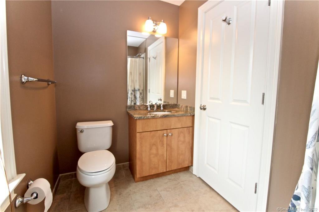 109 Forest Street, Unit 5 Stamford, CT 06901 - Photo 15 of 21 a bathroom with a toilet a sink and a mirror