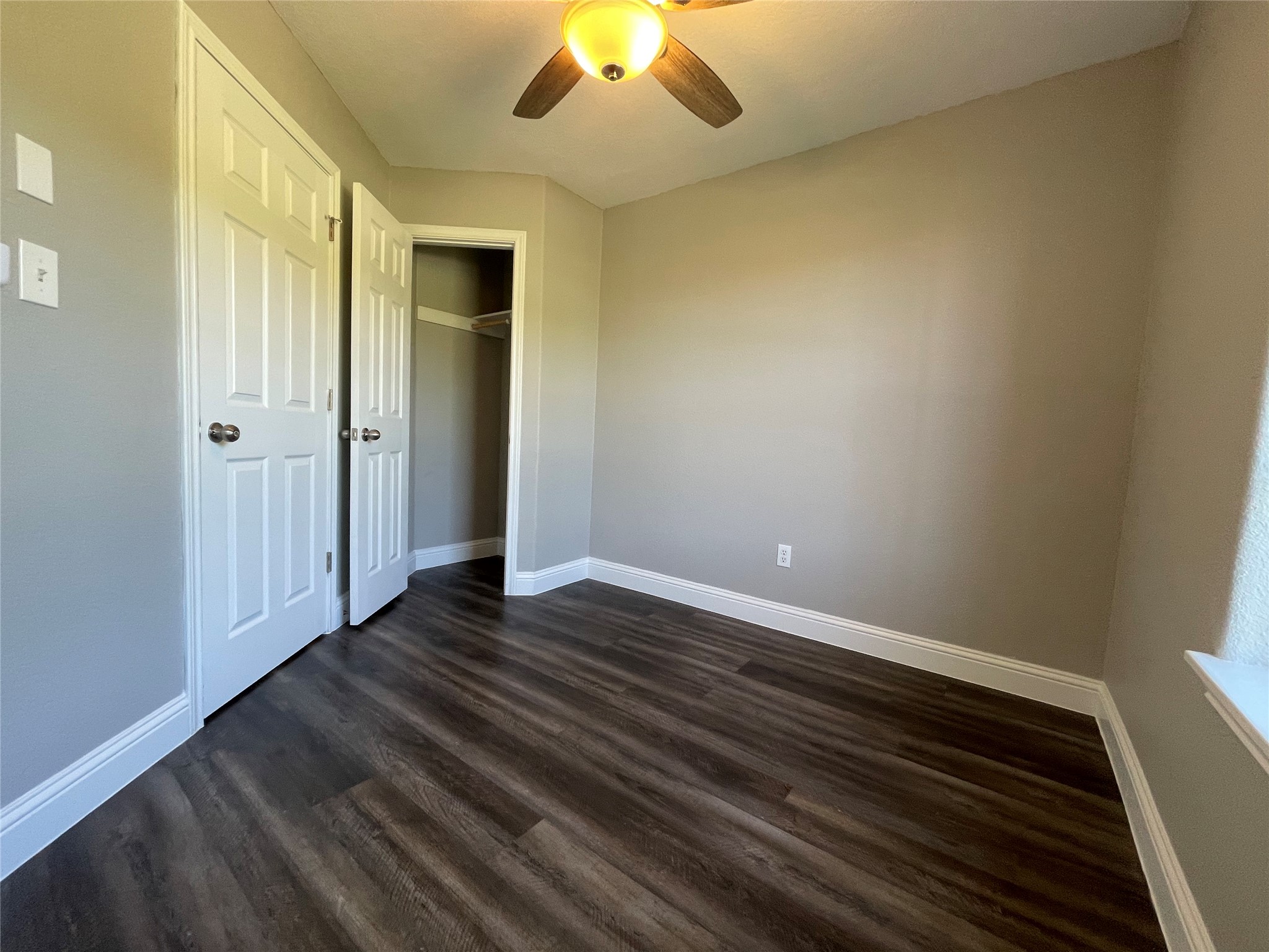 2004 Maple Street Georgetown, TX 78626 - Photo 17 of 31 Room featuring wood-finish flooring, neutral wall tones, and white baseboards