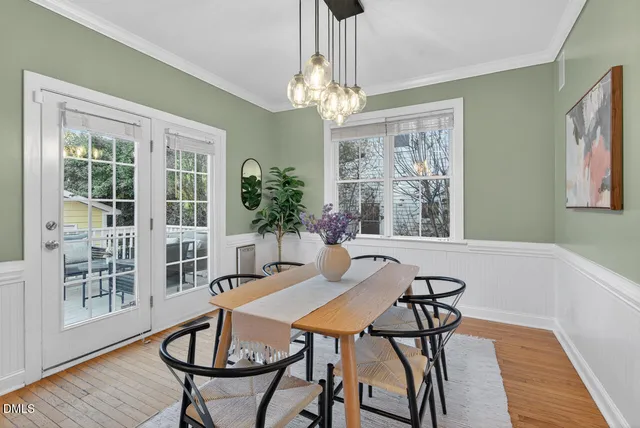 a view of a dining room with furniture and chandelier