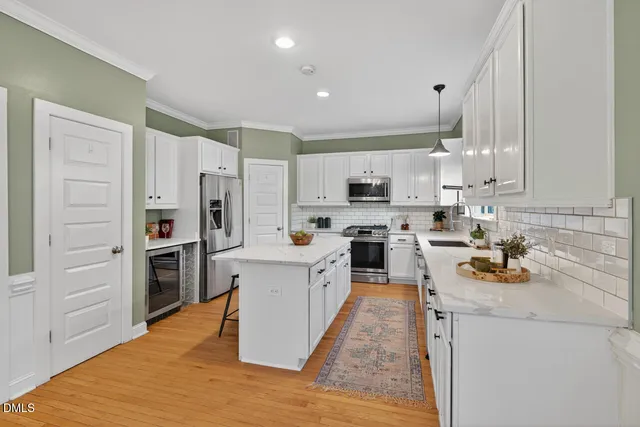a kitchen with stainless steel appliances a stove refrigerator sink and microwave