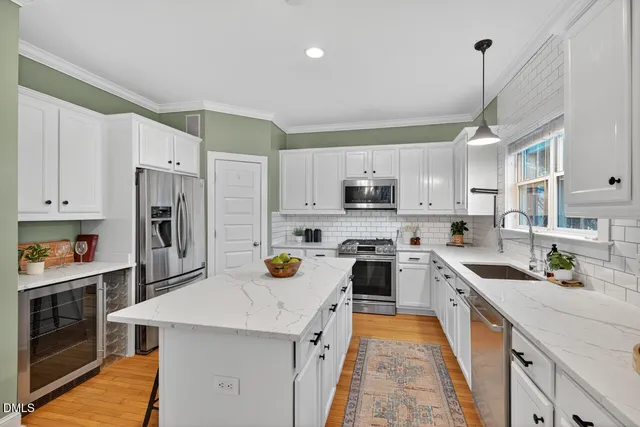 a kitchen with white cabinets and white appliances