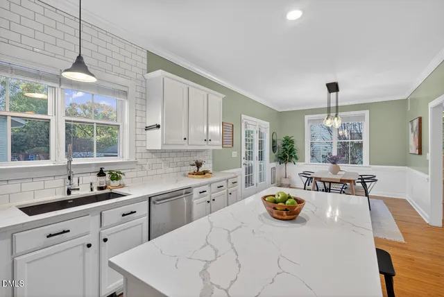 a kitchen with white cabinets and appliances