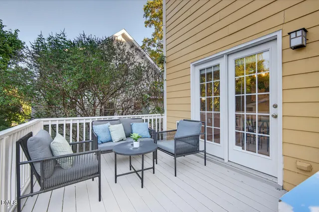 a view of a chair and table on the deck