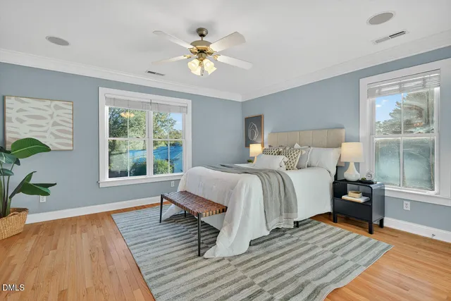 a bedroom with a bed and wooden floor