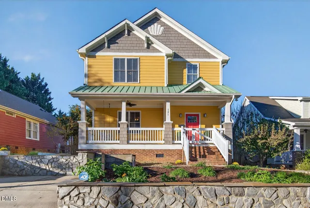 front view of a house with potted plants