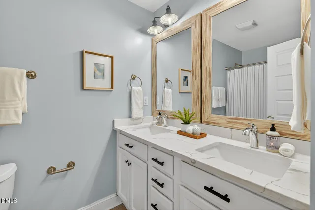 a view of backyard of house with wooden fence