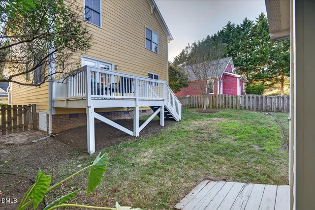 a view of a house with a yard and a garden