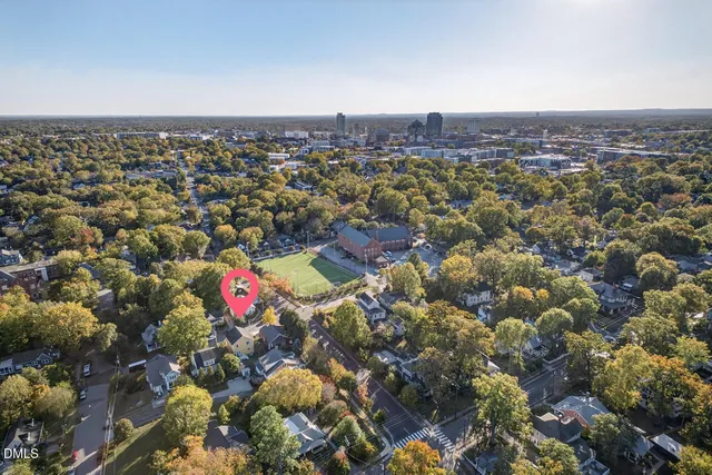 an aerial view of a house with a yard
