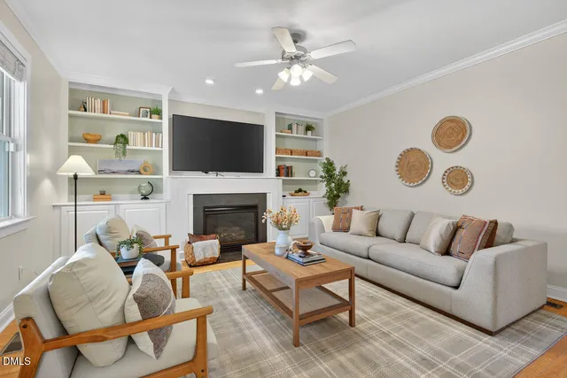 a living room with furniture a fireplace and a flat screen tv