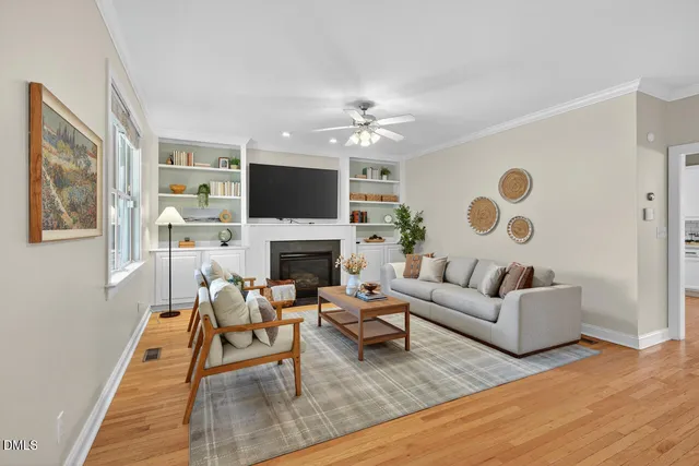 a living room with furniture a flat screen tv and a fireplace