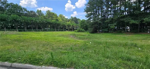 a view of field with trees in the background