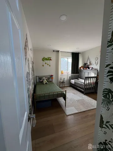 a bedroom with furniture and a wooden floor