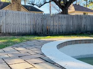 5330 Nodaway Lane Spring, TX 77379 - Photo 13 of 14 a view of a swimming pool with a tub and wooden fence