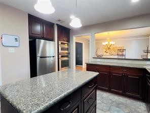 5330 Nodaway Lane Spring, TX 77379 - Photo 9 of 14 a kitchen with stainless steel appliances granite countertop a sink refrigerator and cabinets