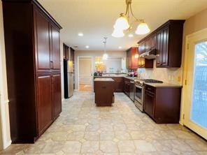 5330 Nodaway Lane Spring, TX 77379 - Photo 10 of 14 a kitchen with stainless steel appliances granite countertop a stove refrigerator and kitchen island