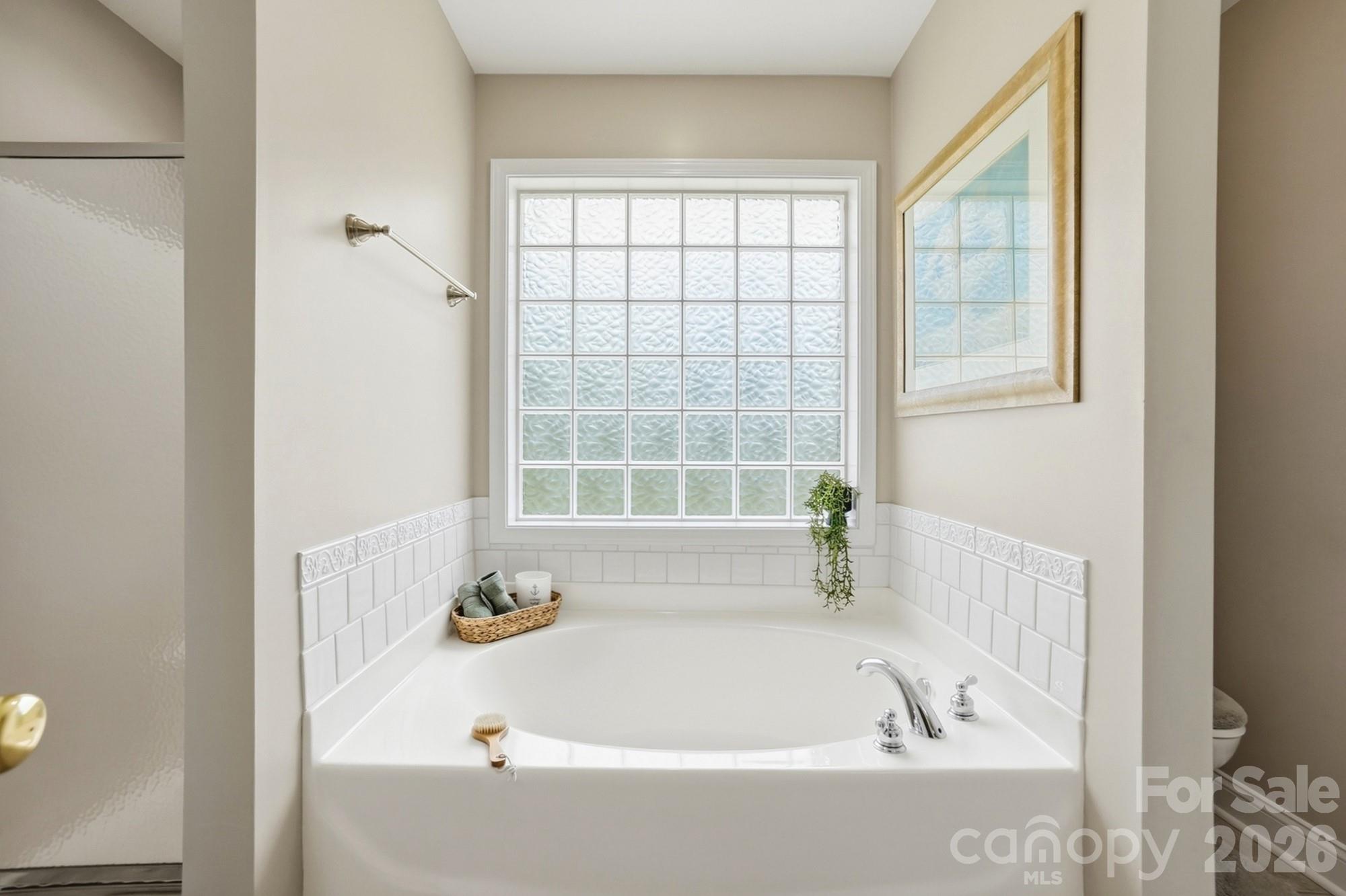 3324 Muddy Creek Road Midland, NC 28107 - Photo 29 of 46 a bathroom with bathtub and window