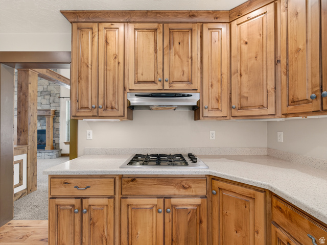 1279 West 1500th Street North Mapleton, UT 84664 - Photo 23 of 83 Kitchen featuring wood cabinetry, light-toned countertops, a built-in gas cooktop, and an overhead range hood