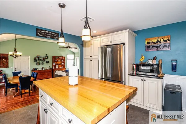 a kitchen with stainless steel appliances granite countertop a sink a refrigerator and a stove