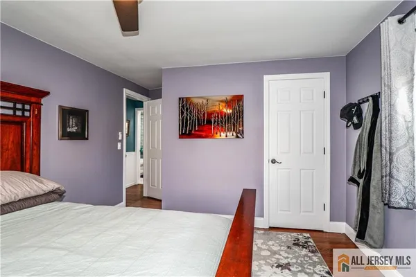 a living room with furniture a flat screen tv and a window