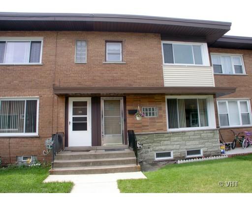 10065 Frontage Road, Unit E Skokie, IL 60077 - Photo 1 of 1 a front view of a house with a yard