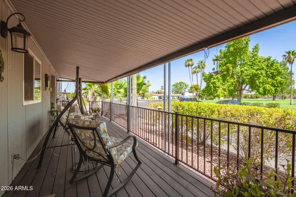 a view of a garage with a table and chairs under an umbrella