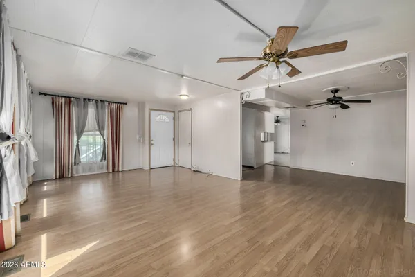 wooden floor in an empty room with a window