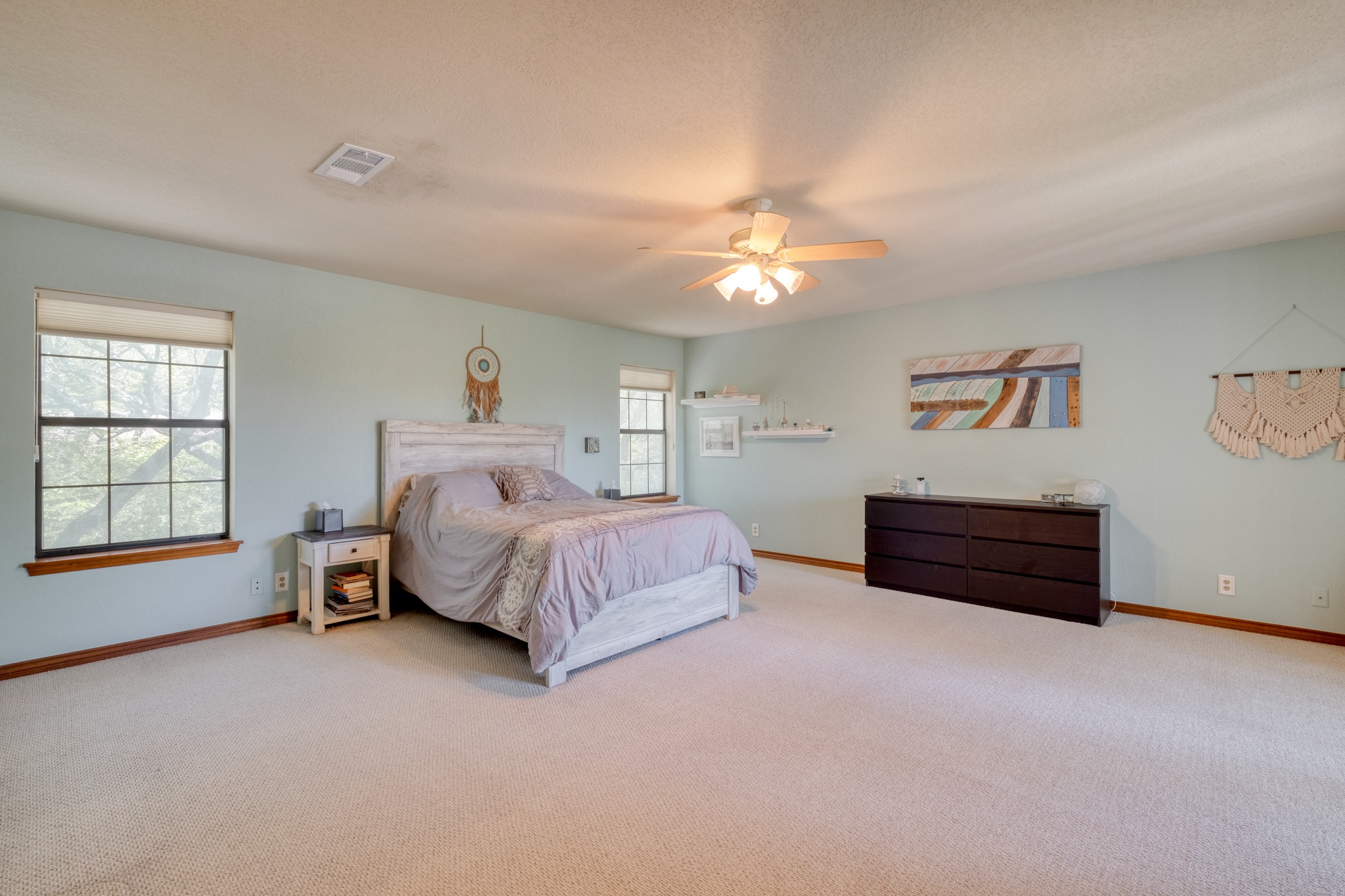 202 Ridgewood Drive Georgetown, TX 78628 - Photo 20 of 40 a spacious bedroom with a bed and a chandelier