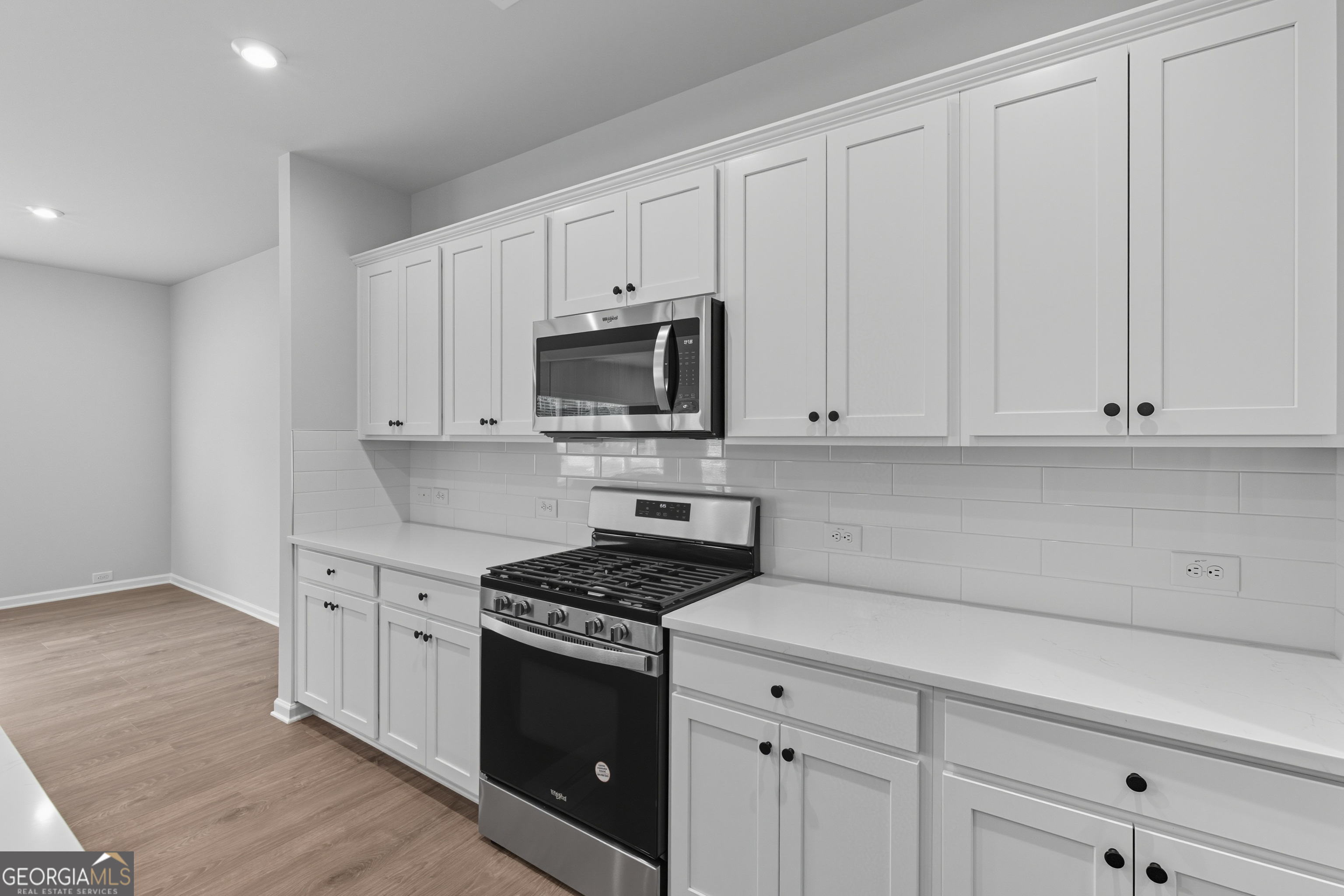 103 Everest Court Dallas, GA 30132 - Photo 17 of 35 a kitchen with granite countertop white cabinets and stainless steel appliances