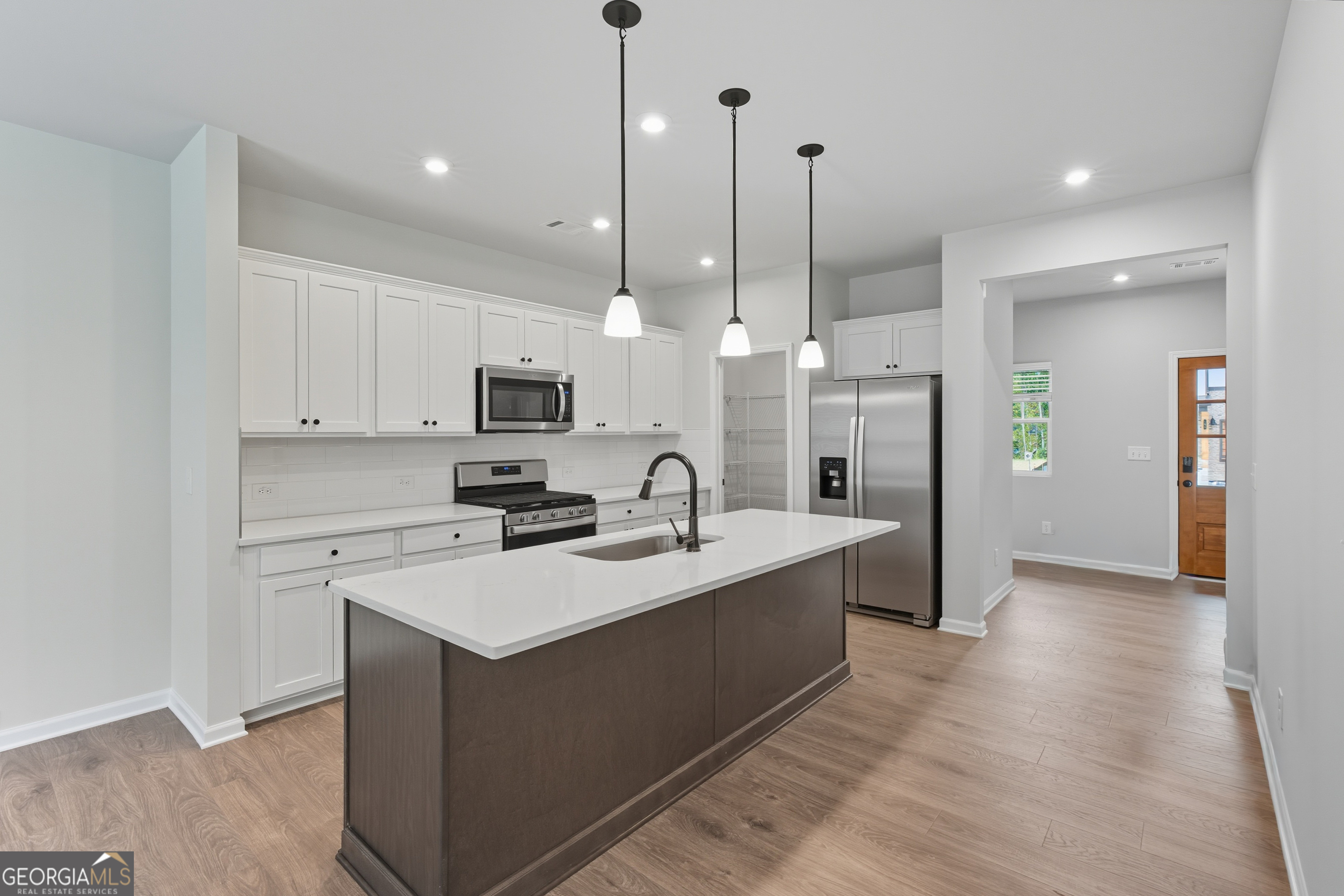 103 Everest Court Dallas, GA 30132 - Photo 18 of 35 a view of a kitchen with kitchen island a sink stainless steel appliances and cabinets