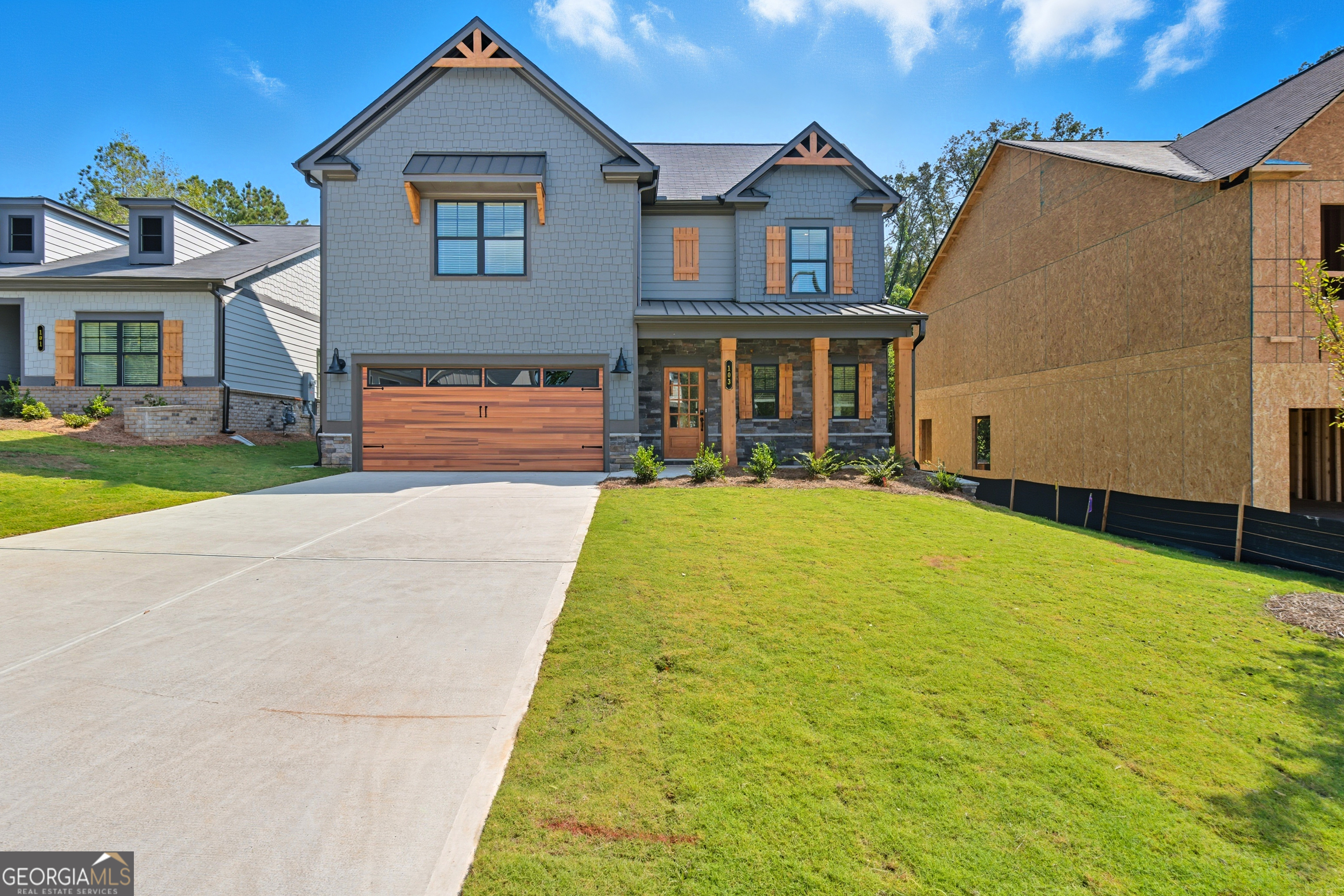 103 Everest Court Dallas, GA 30132 - Photo 2 of 35 a front view of a house with a yard and garage