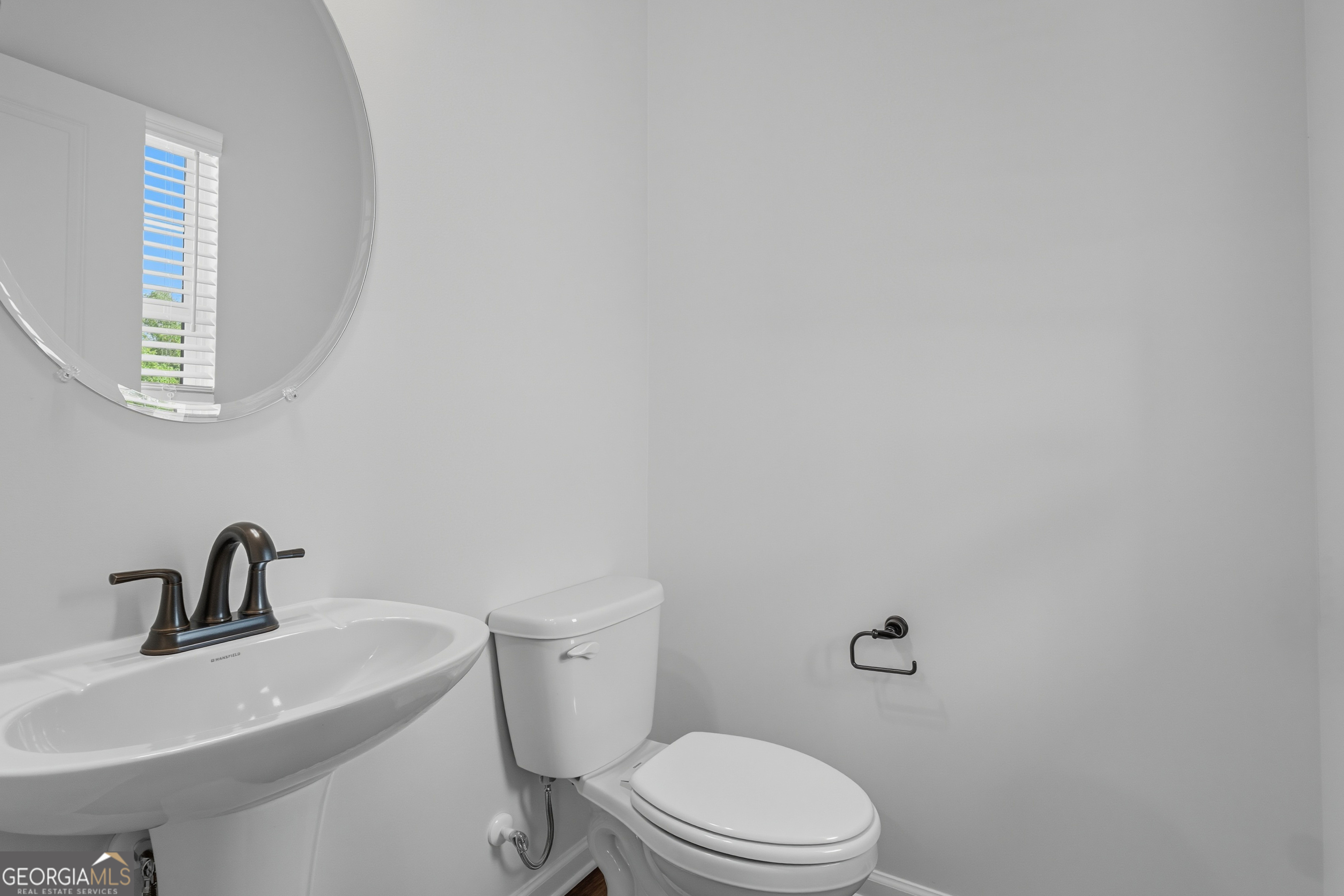 103 Everest Court Dallas, GA 30132 - Photo 24 of 35 a white toilet sitting next to a bathroom sink