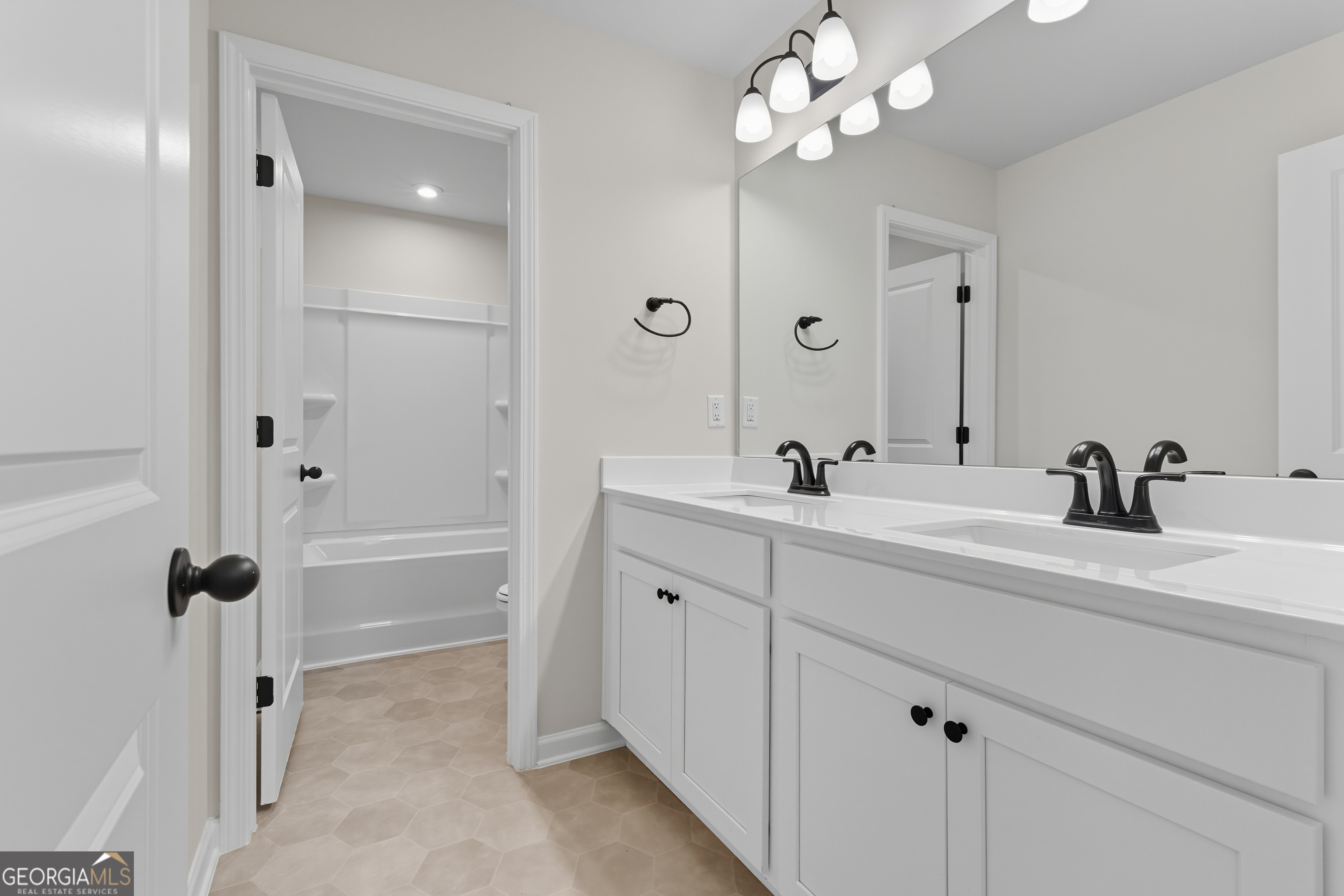 103 Everest Court Dallas, GA 30132 - Photo 32 of 35 a spacious bathroom with a double vanity sink a mirror and a shower