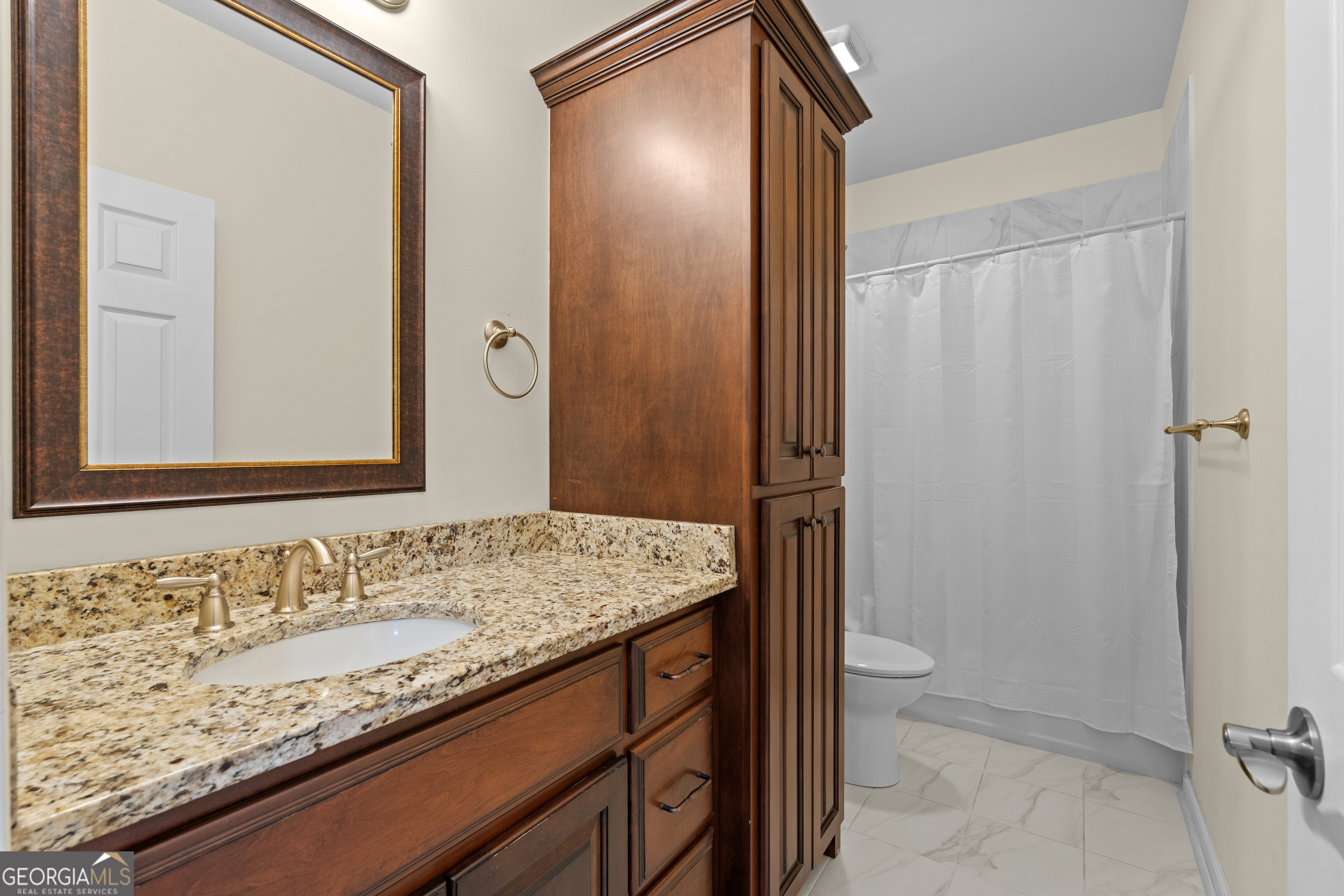 733 Cherry Road Franklin, GA 30217 - Photo 30 of 67 a bathroom with a granite countertop sink and a mirror